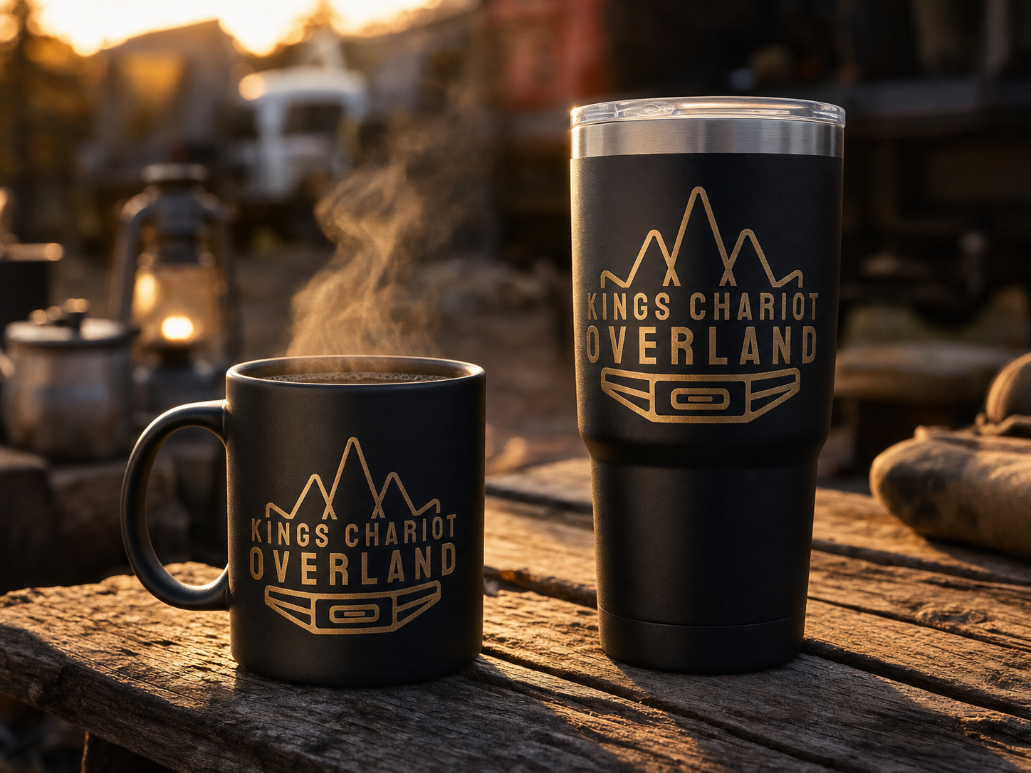 Matte black ceramic camp coffee mug and double-wall stainless steel 30oz insulated tumbler, both engraved with the King's Chariot Overland logo in gold